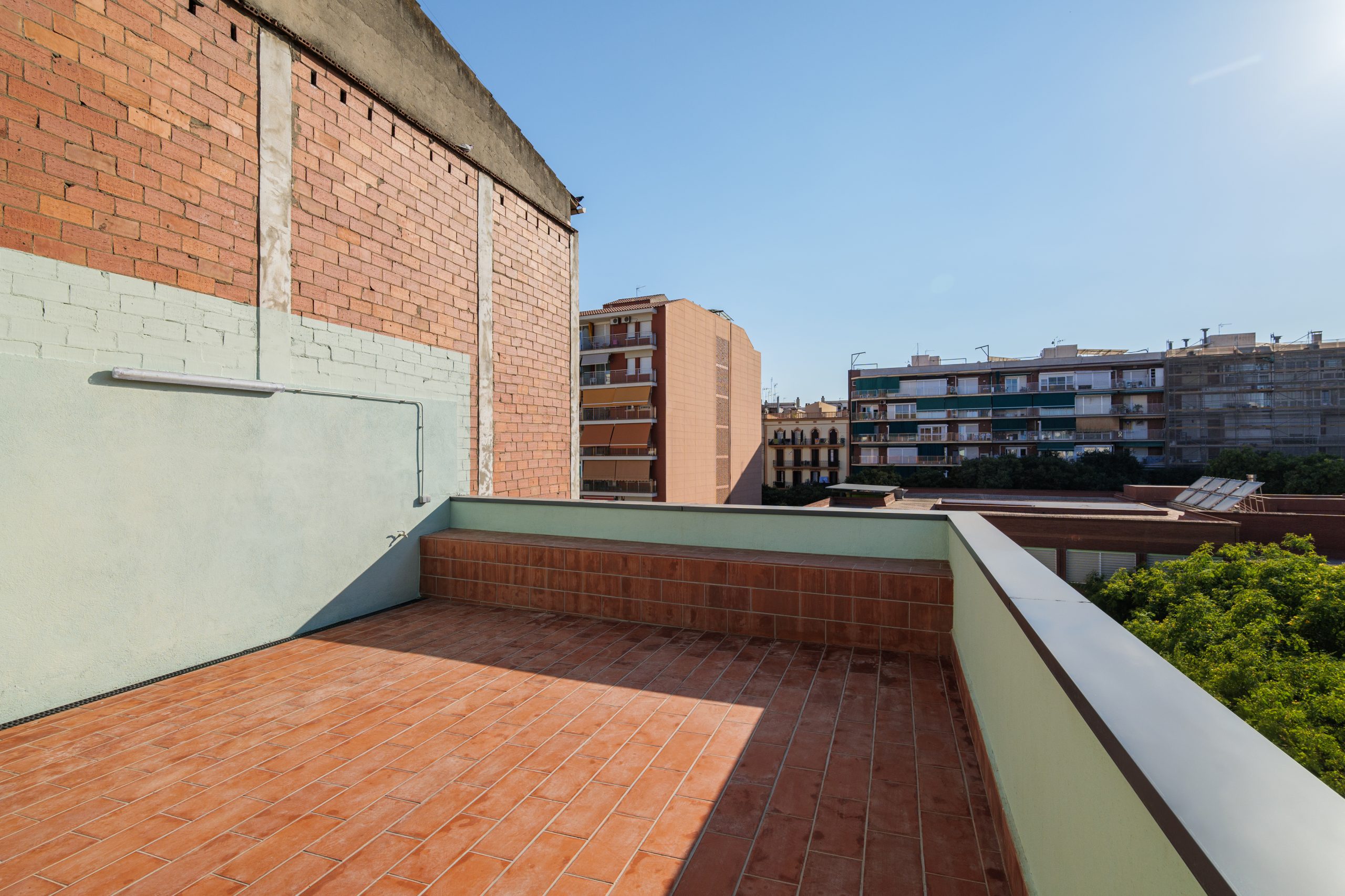 empty-terrace-roof-modern-building-barcelona-spain-view-city-blue-sky-sun